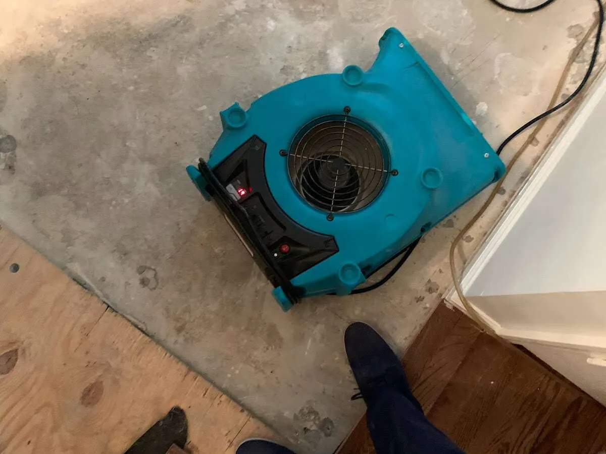 Air mover drying subfloor during Commercial Water Damage Restoration in Soledad